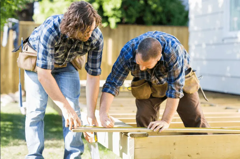 Deck contractors inspecting a deck frame in Eugene, Oregon