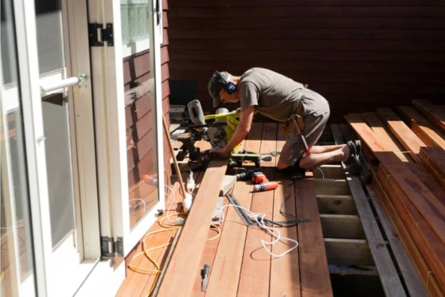 Deck contractor installing new deck boards on a residential deck in Eugene