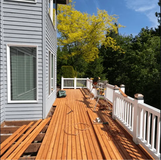 Deck with white vinyl railing during a repair project