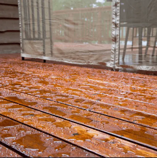 Water no longer beading on a deck surface, indicating the sealant has worn off